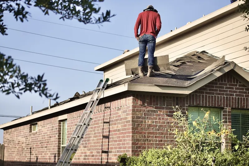 Professional roofer working on a residential roof in Old Lake Highlands